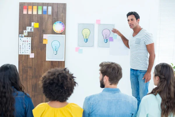 Creative business people at work by blackboard — Stock Photo, Image