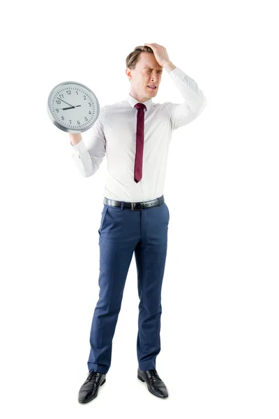 Hombre de negocios ansioso sosteniendo un reloj — Foto de Stock