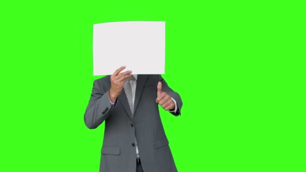 Businessman standing with page over face — Stock Video