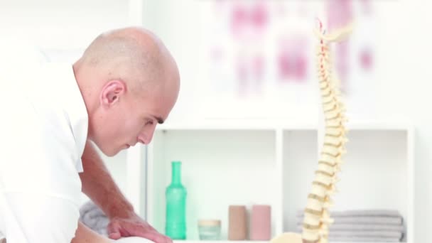 Physiotherapist doing back massage to his patient — Stock Video