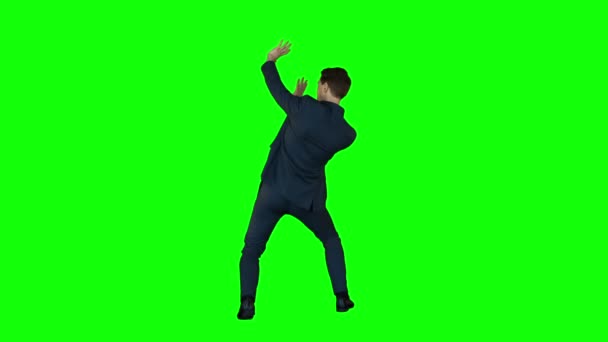 Businessman protecting himself  on green screen — Stock Video