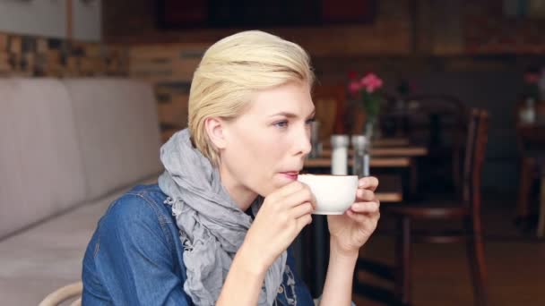 Happy blonde drinking coffee — Stock Video