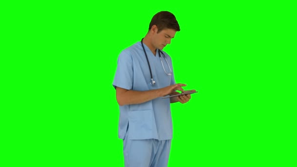 Surgeon standing using his tablet pc — Stock Video