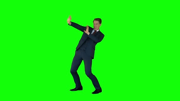 Businessman protecting himself  on green screen — Stock Video