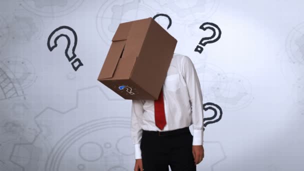 Businessman looking down with box on head — Stock Video