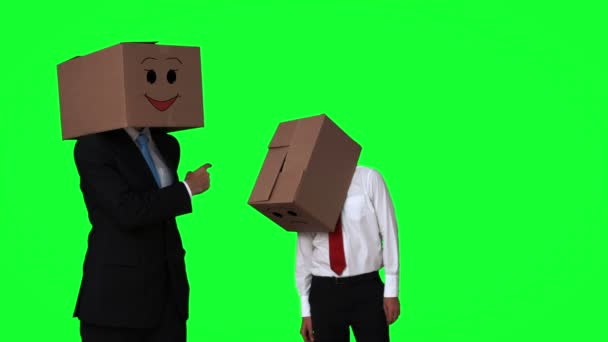 Team of businessmen hiding heads with boxes — Stock Video
