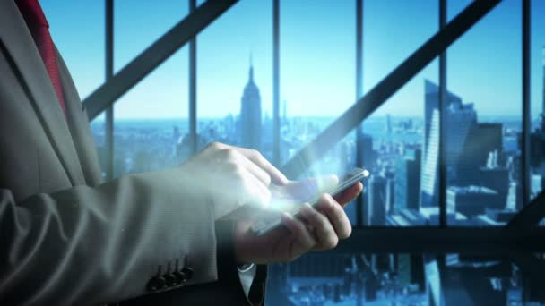 Businessman using smartphone with skyscraper — Stock Video