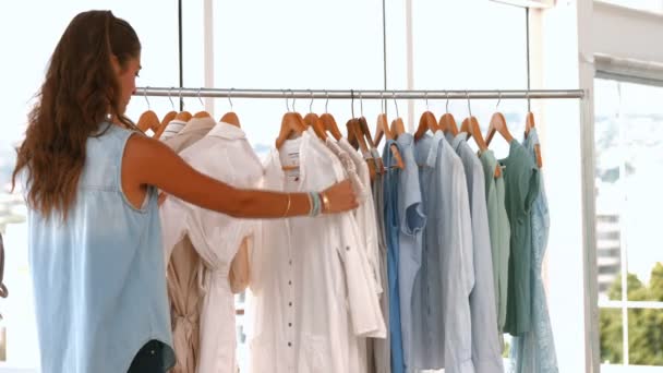 Projektant mody, patrząc w szafie ubrania — Wideo stockowe