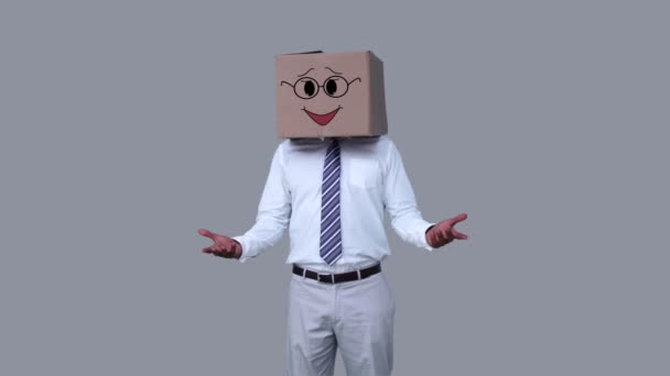 Businessman hiding head with happy box — Stock Video