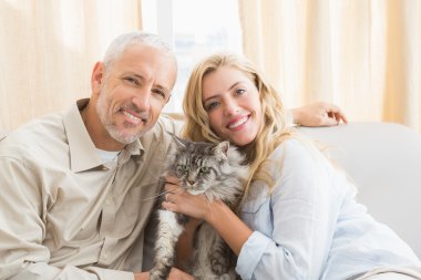 couple with cat on sofa clipart