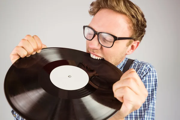Hipster biting vinyl record — Stock Photo, Image