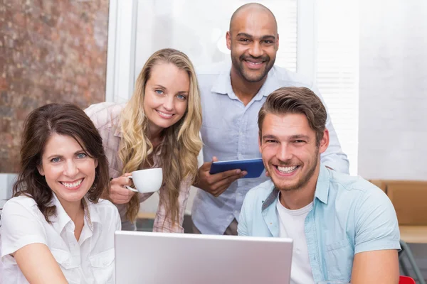 Businesspeople looking behind laptop — Stock Photo, Image