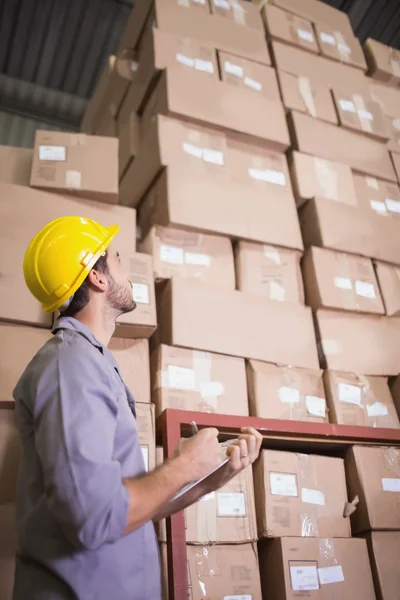 Worker clipboard in warehouse — Stock Photo, Image