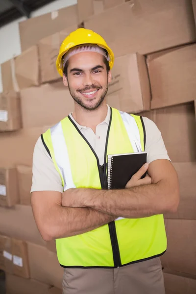 Worker with diary in warehouse — Stock Photo, Image