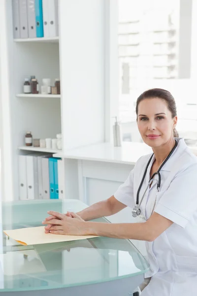 Doctor sitting at desk — Stock Photo, Image