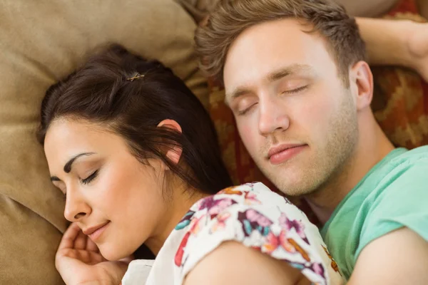 Couple cuddling on couch — Stock Photo, Image