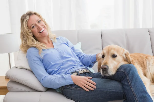 Woman petting golden retriever — Stock Photo, Image