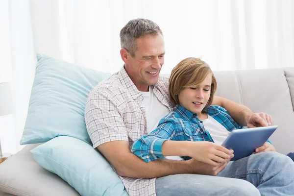 Pai com filho relaxante no sofá — Fotografia de Stock