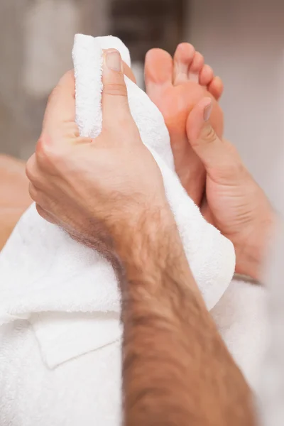 Pedicurist massaging customers foot — Stock Photo, Image