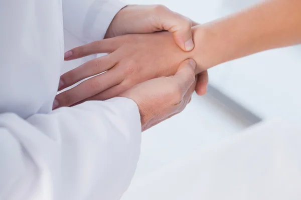 Doctor examining patients hand — Stock Photo, Image