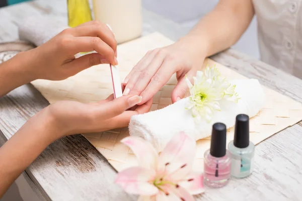 Nail technician giving custome manicure — Stock Photo, Image