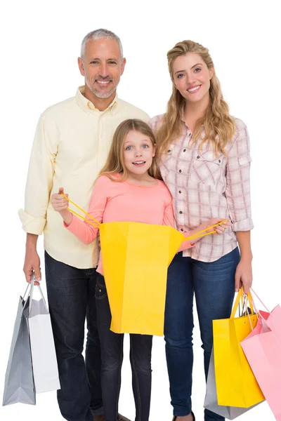 Föräldrar och dotter med kassar och påsar — Stockfoto