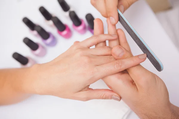 Manicurist filing customers nails — Stock Photo, Image