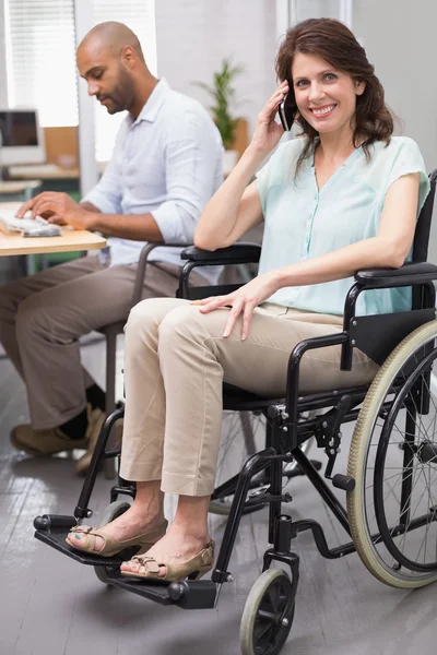 Zakenvrouw in rolstoel texting op telefoon — Stockfoto