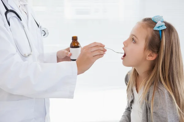 Girl taking medicine — Stock Photo, Image