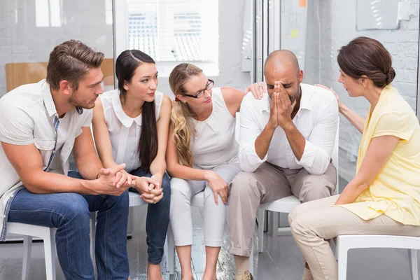 Business team supporting sad colleague — Stock Photo, Image