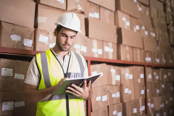 Worker with diary in warehouse — Stock Photo, Image