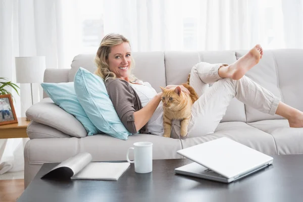 Woman cuddling ginger cat — Stock Photo, Image