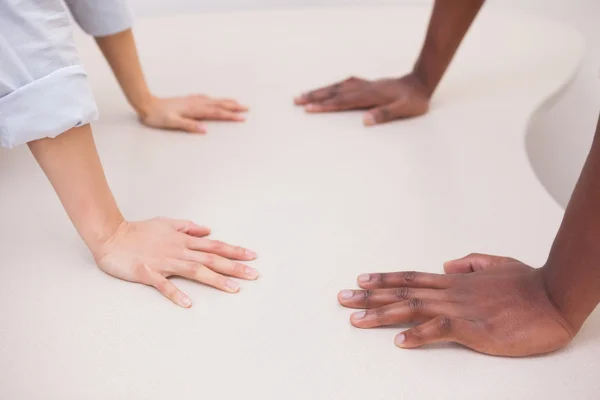 Business colleagues with hands on desk — Stock Photo, Image