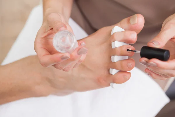 Pedicurist painting customers nails — Stock Photo, Image