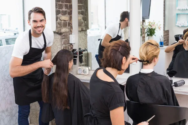 Hairdressers working on clients — Stock Photo, Image