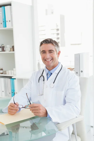 Doctor sitting at desk — Stock Photo, Image