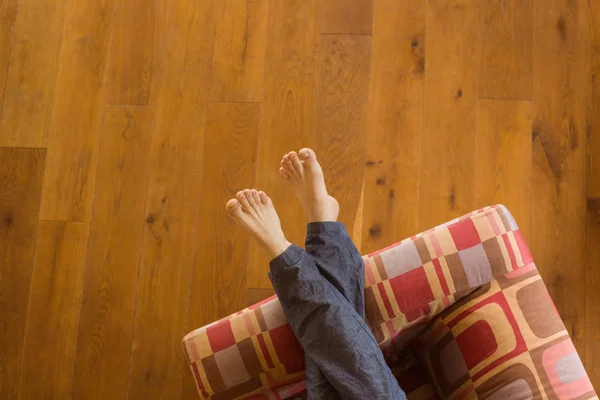 Male legs on couch — Stock Photo, Image