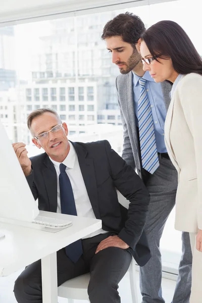 Business people looking at computer — Stock Photo, Image