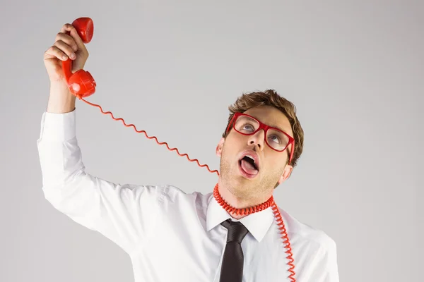 Businessman strangling himself with telephone — Stock Photo, Image