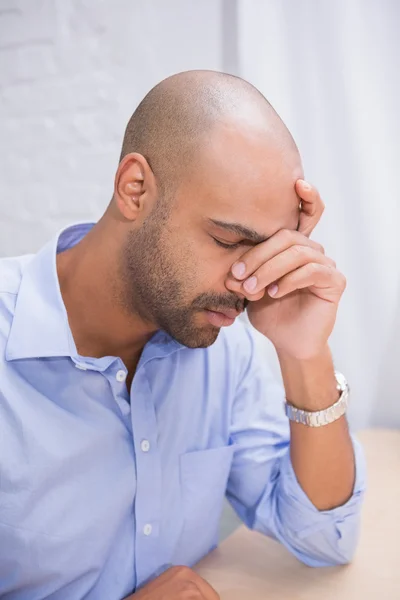 Businessman with head in hand — Stock Photo, Image