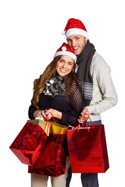 Par i santa hattar med gåvor — Stockfoto