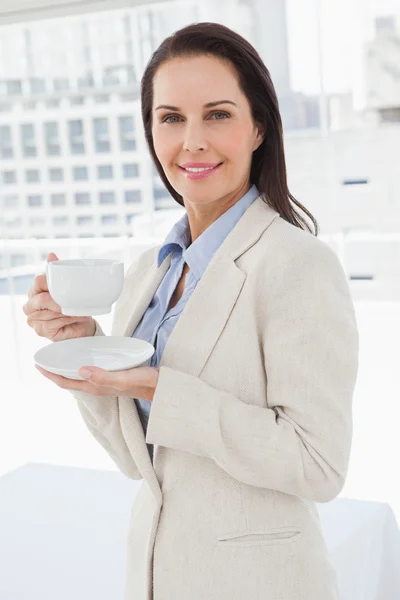 İş kadını elinde kahve fincanı tutuyor — Stok fotoğraf