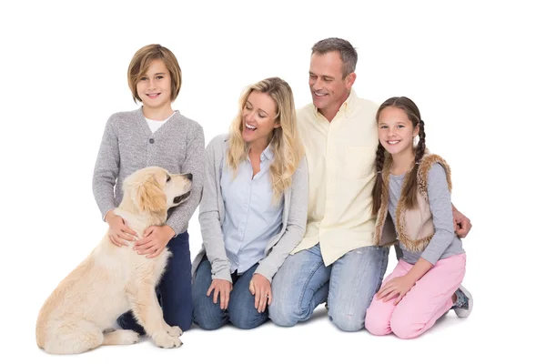 Family with dog smiling at camera — Stock Photo, Image