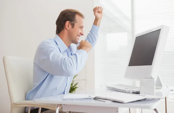 Businessman cheering at desk — Stock Photo, Image