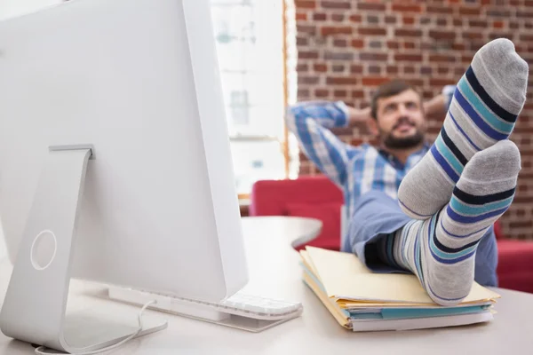 Businessman with feet up on desk — Stock Photo, Image