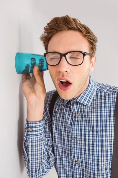 Businessman eavesdropping with cup — Stock Photo, Image