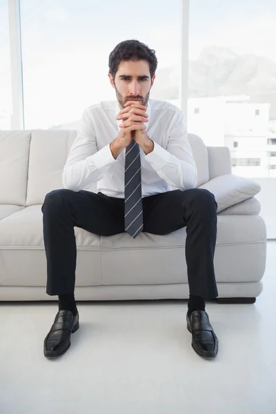Businessman sitting on couch — Stock Photo, Image