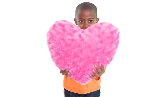 Boy showing pink heart pillow — Stock Photo, Image