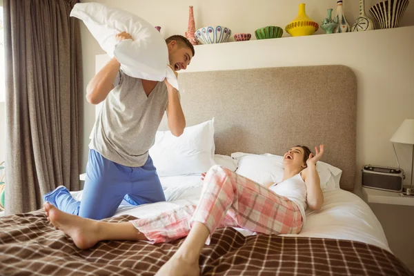 Couple having pillow fight — Stock Photo, Image