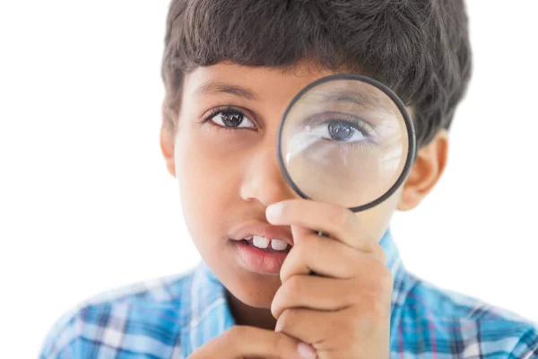 Boy looking through magnifying glass — Stock Photo, Image